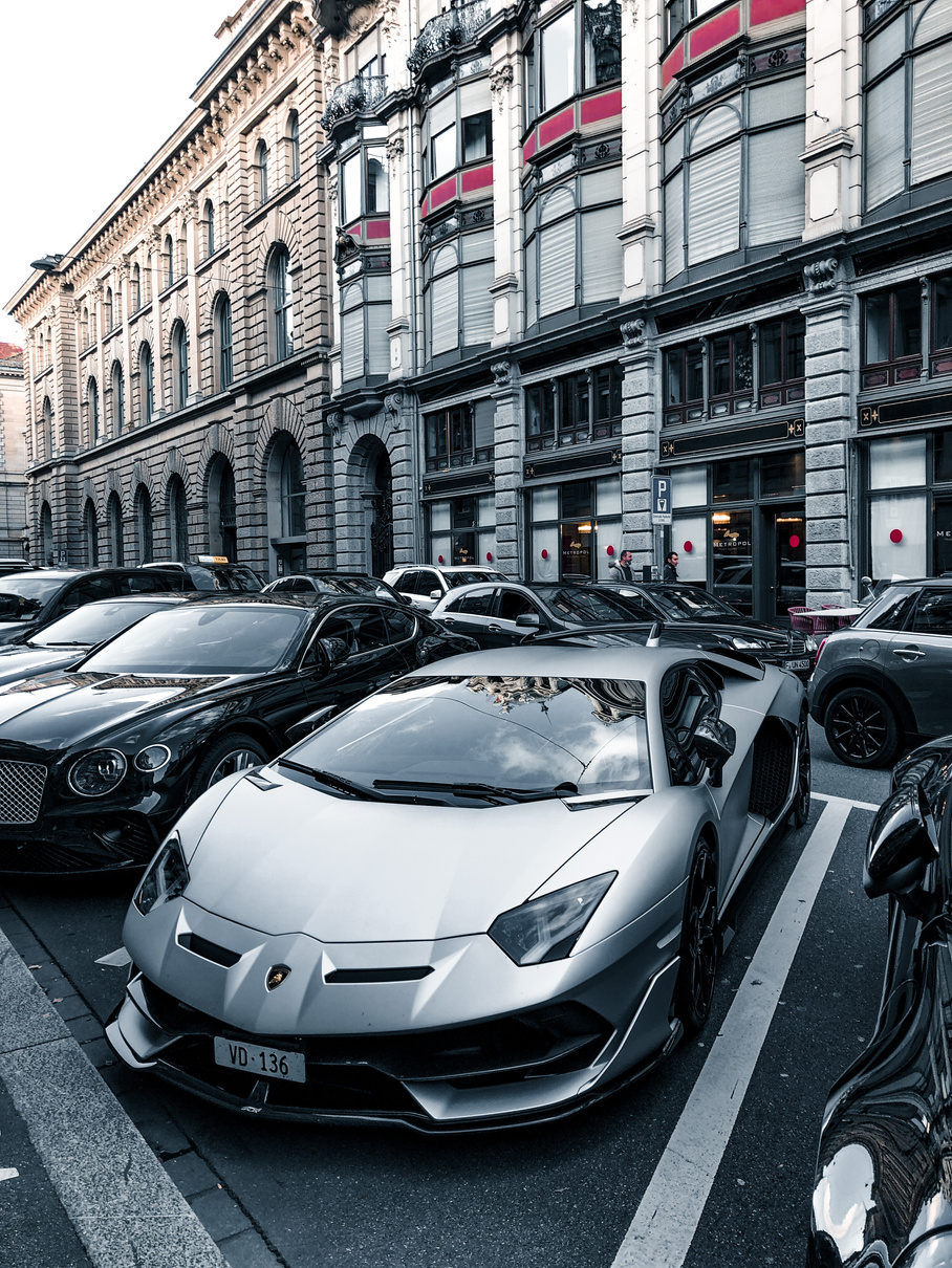 Luxury Cars Parked on the Side of the Road Near the Buildings